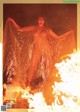 A woman standing in front of a fire covered in plastic.